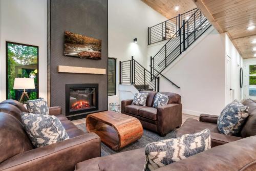 a living room with couches and a fireplace at Spring Splash Retreat - Pool Hot Tub & Games in Catlettsburg