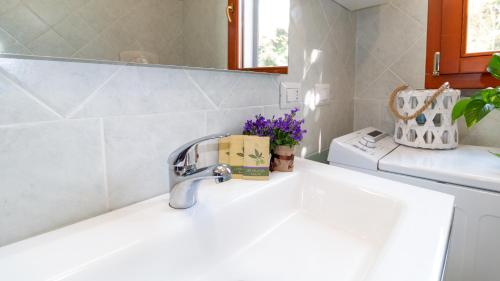 a kitchen sink with a faucet on a counter at Lovely and Quite - Bosa by Sardinianworld in Bosa