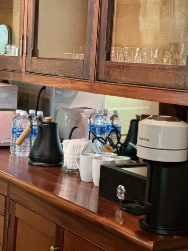 a kitchen counter with a coffee maker and cups on it at The Underwood-Hale House in Providence