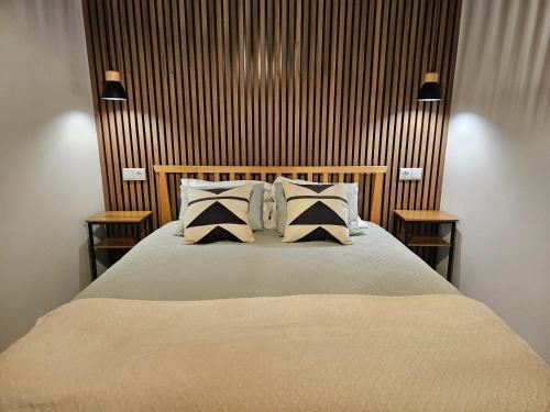 a bedroom with a large bed with two night stands at Cozy House in Furnas with Mountain View in Furnas