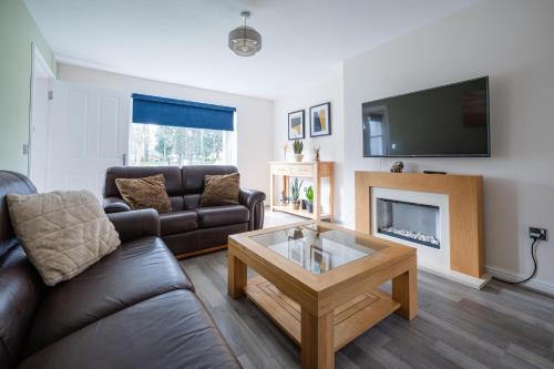 a living room with a couch and a coffee table at 3-Bed Home Near Town Center in Stirling