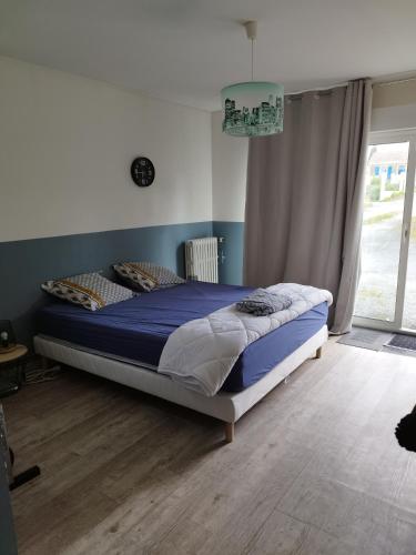 une chambre avec un lit dans une pièce avec une fenêtre dans l'établissement chezsylvilla, à Saint-Agnant