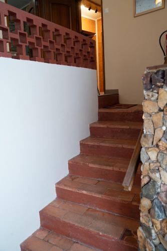 a set of stairs in a house with a stone wall at Apartamento Escadinhas do Castelo in Monchique