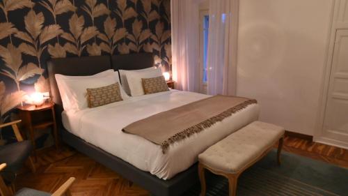 a bedroom with a king sized bed and a chair at Villa del Parco in Poggi