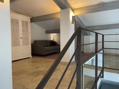 a staircase leading to a living room with a couch at Mas des Cèdres in Ménerbes