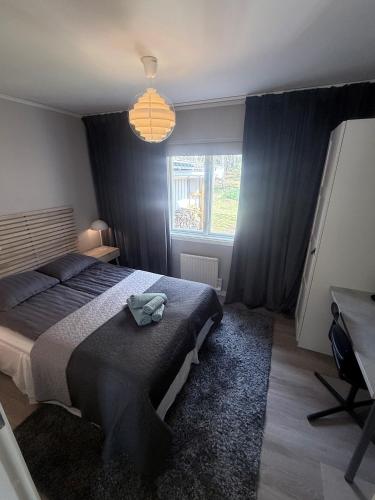 a bedroom with a bed with a hat on it at New Small house Uppsala in Uppsala
