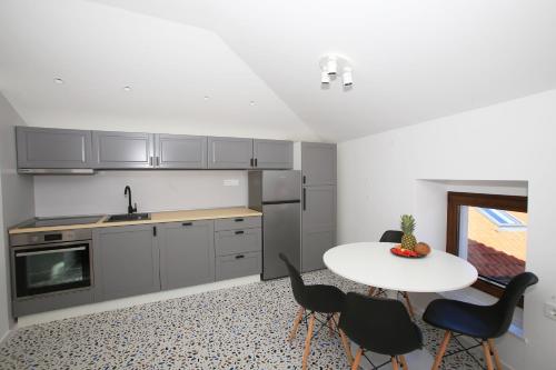 a kitchen with a table and chairs and a sink at Villa Ula Premium Apartments ,Free Private PARKING in Opatija