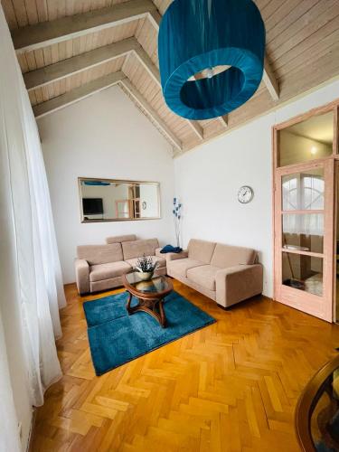 a living room with a couch and a table at GreenPark Garden Villa Family Apartments Near Tokaj in Szerencs