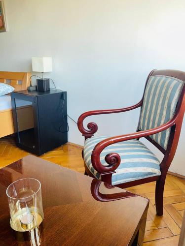 a living room with a chair and a coffee table at GreenPark Garden Villa Family Apartments Near Tokaj in Szerencs