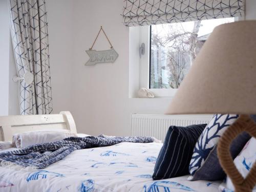 a bedroom with a bed and a window at Large Riverside Retreat With Panoramic Dart Views in Dartmouth