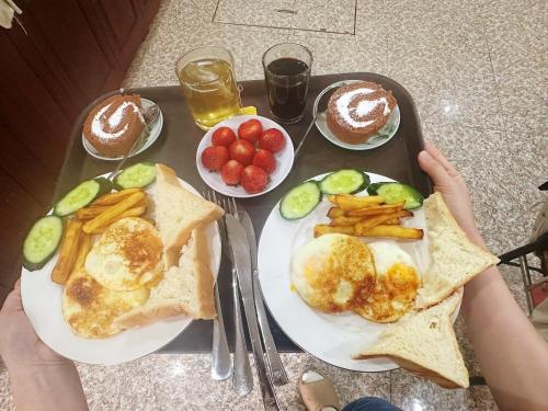 a tray of food with eggs and french fries at Khách Sạn Tiến Loan in Hòa Bình