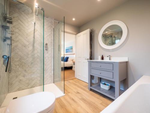a bathroom with a shower and a toilet and a sink at Family-friendly Bungalow Near Thurlestone Beach in Thurlestone