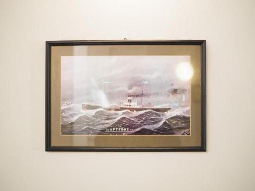 a painting of a boat in the water at Filoxenia Hotel in Chios