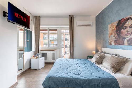 a bedroom with a blue bed and a tv at Bnb Drive In in Rome