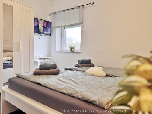 a bed with two pillows on it in a room at Ferienhaus Nordkönig mit Sauna und Whirlpool in Langen
