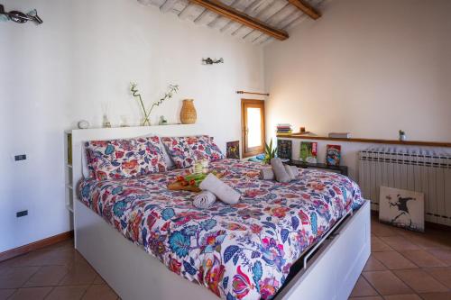 a bedroom with a large bed with a colorful bedspread at Bloom and Wood in Padova