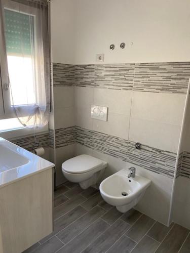 a bathroom with a toilet and a sink at La Giara in Alghero