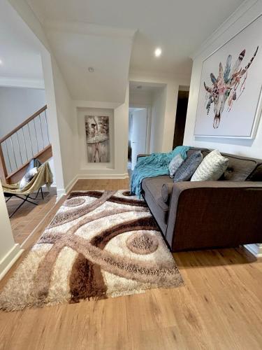 a living room with a couch and a rug at Villa with Spa and Breathtaking Views of Dandenong Ranges in Kalorama