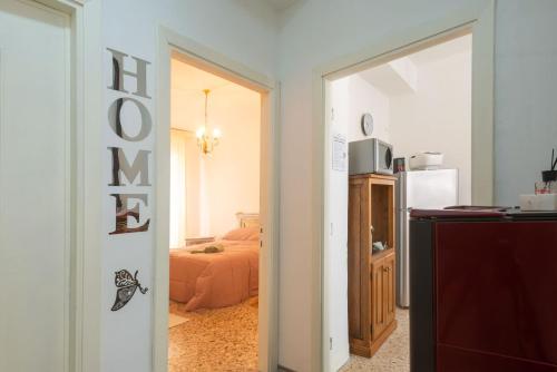 a room with a bed and a door to a bedroom at La casetta in centro in Tempio Pausania