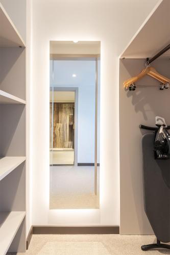 a hallway with a glass door leading into a room at Hotel Jurmala Spa in Jūrmala