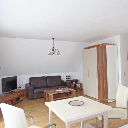 a living room with a couch and a table at Ferienwohnung-3-im-Haus-Baltique in Glowe