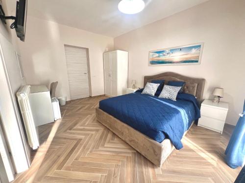 a bedroom with a bed with a blue comforter at La Casa di Nina in Castelnuovo Cilento