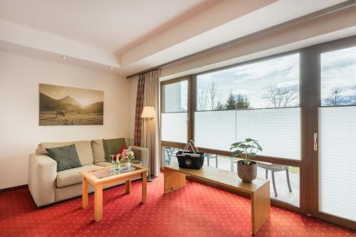 a living room with a couch and a table at Landhotel Gockelwirt in Eisenberg