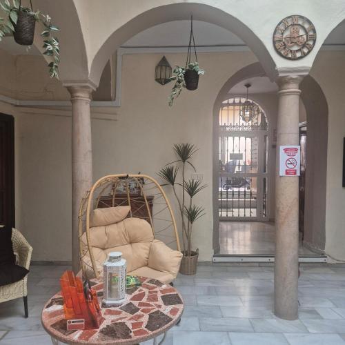 a living room with a couch and a table at Pensión Javier in Seville