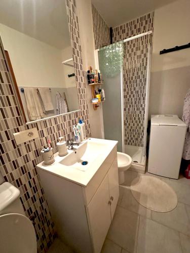 une salle de bain avec un lavabo, des toilettes et une douche dans l'établissement Mini-villa située à 5 minutes de la plage de Pinarello à pieds, à Pinarellu