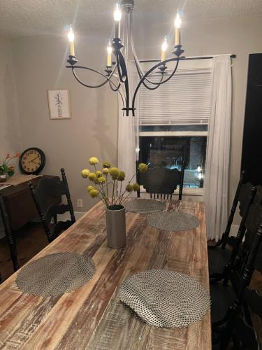 a dining room table with a chandelier at yellow house downtown in Des Moines