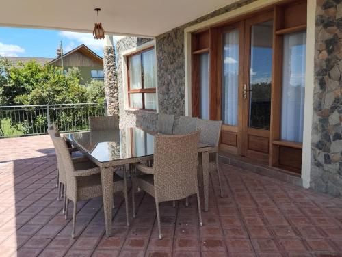 a dining table and chairs on a patio at Sangare Hills Country Homes & Resort in Mweiga