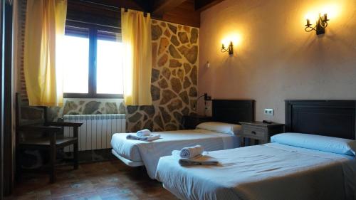 Postel nebo postele na pokoji v ubytování Casa Rural Vallecasar