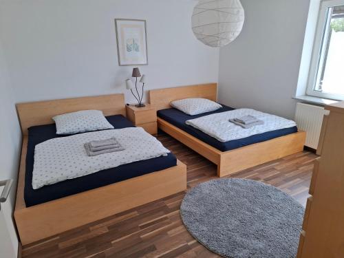 a bedroom with two beds and a rug at Kurstadt-Appartement Bad Wildungen in Bad Wildungen