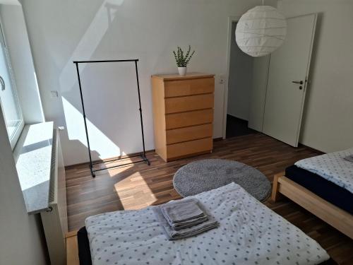 a bedroom with a bed and a dresser and a mirror at Kurstadt-Appartement Bad Wildungen in Bad Wildungen