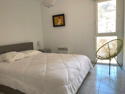 une chambre avec un lit, une chaise et une fenêtre dans l'établissement Bel Appartement T2 avec Terrasse et Garage à Balaruc-les-Bains - FR-1-553-269, à Balaruc-les-Bains