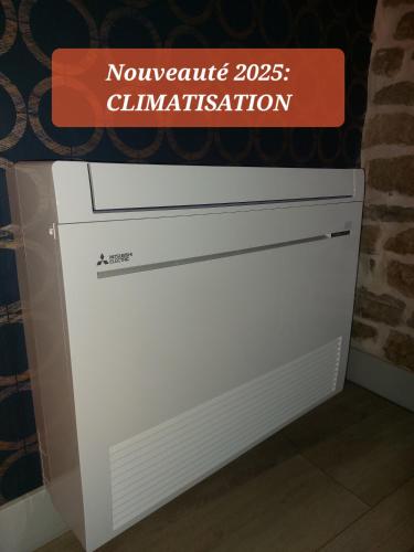 a white dresser with a sign on top of it at L'INATTENDU Vue imprenable,clim,parking avec borne de recharge, ménage inclus in Montaigu