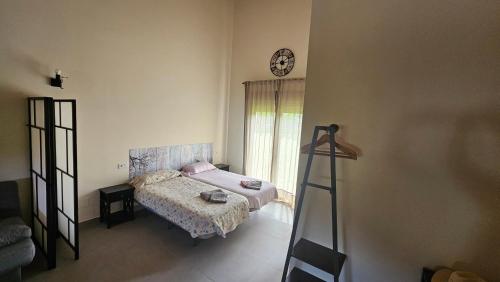 a bedroom with a bed and a clock on the wall at Mi Casa en Guriezo in Angostina