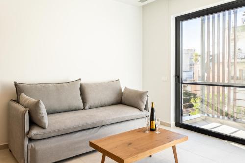a living room with a couch and a table at Grec Suites Dafni, Athens by GrecCollection in Athens