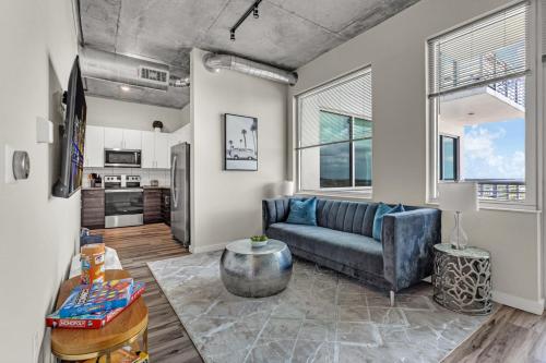 a living room with a couch and a table at Live the Downtown Life Cozy 1 Bed Near Tropicana in St. Petersburg