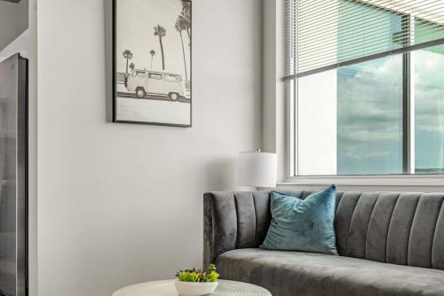 a living room with a couch and a window at Live the Downtown Life Cozy 1 Bed Near Tropicana in St. Petersburg