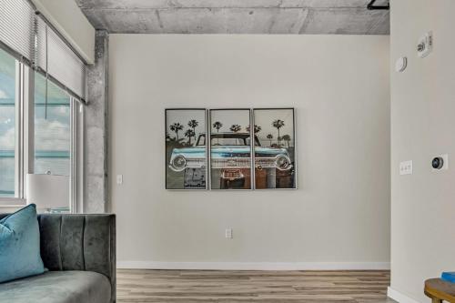 a living room with a picture of a car on the wall at Live the Downtown Life Cozy 1 Bed Near Tropicana in St. Petersburg
