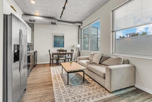 a living room with a couch and a table at Experience St. Pete Charming 1 Bed by Tropicana in St. Petersburg