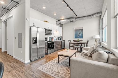 a living room with a couch and a table at Experience St. Pete Charming 1 Bed by Tropicana in St. Petersburg
