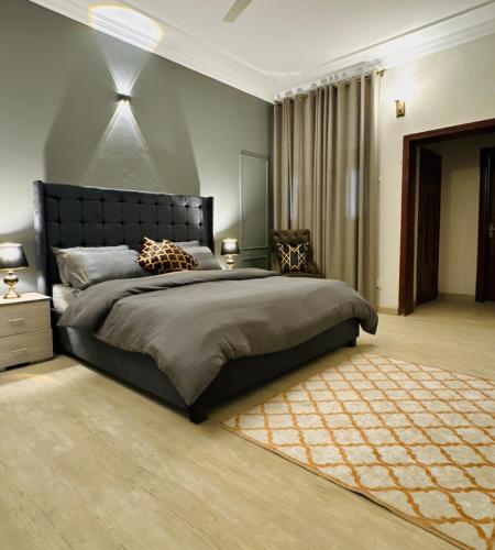 a bedroom with a large bed and a rug at 3 BDR F10-1 Escape in Islamabad