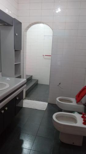 a bathroom with two toilets and a sink at Pousada Santa Fé in Aparecida