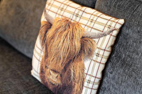 a pillow with an animal head on a couch at Saughton Suite with views of Water of Leith in Edinburgh