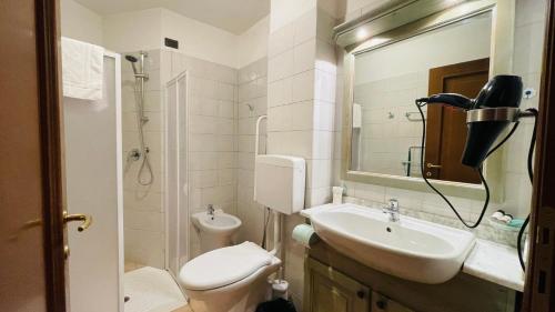 a bathroom with a sink and a toilet and a shower at Residence Villa Frejus in Bardonecchia