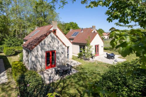an aerial view of a house with a red door at Vacation house with sunny garden near lake in Ewijk