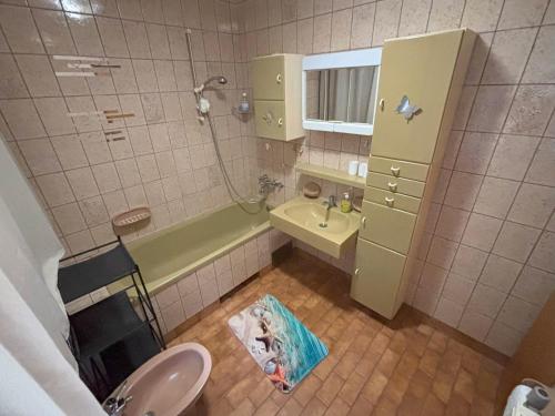 a small bathroom with a sink and a tub at Apartment Panorama in Zreče