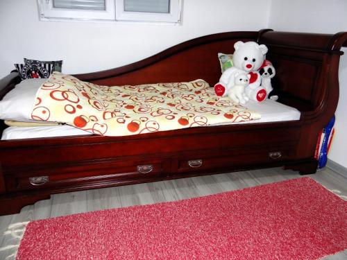 two stuffed animals are sitting on a bed at Kuca Aura in Višegrad